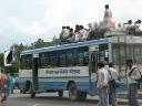 Riders on top of bus